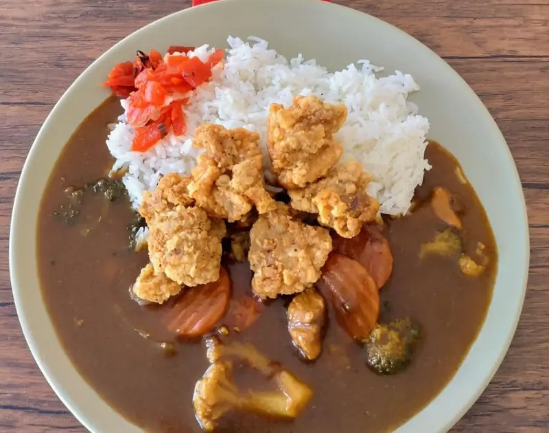 A plate of karaage fried chicken with Japanese curry and rice